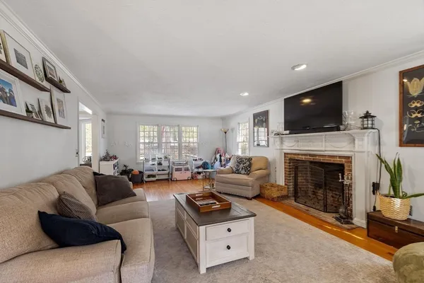 a living room with furniture a flat screen tv and a fireplace