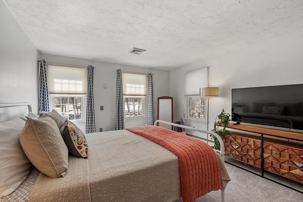 92 Prospect Street Lunenburg, MA 01462 - Photo 26 of 42 a bedroom with a bed and a flat screen tv