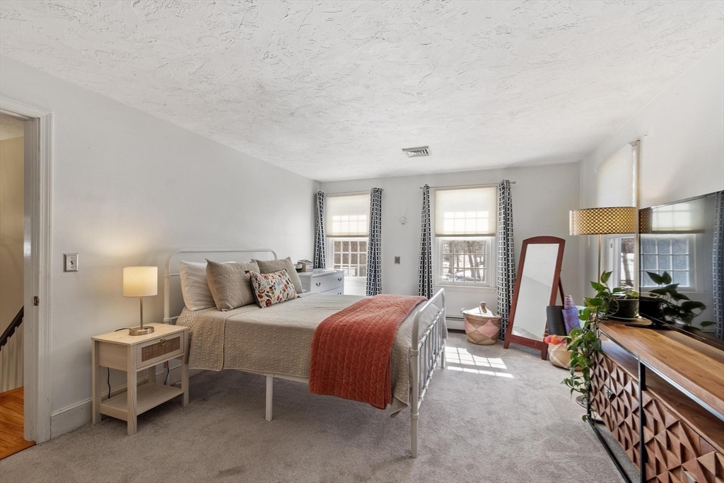 92 Prospect Street Lunenburg, MA 01462 - Photo 27 of 42 a bedroom with bed a lamp and window