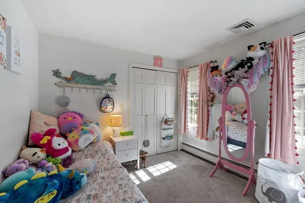 a bedroom with a bed a couch and dresser