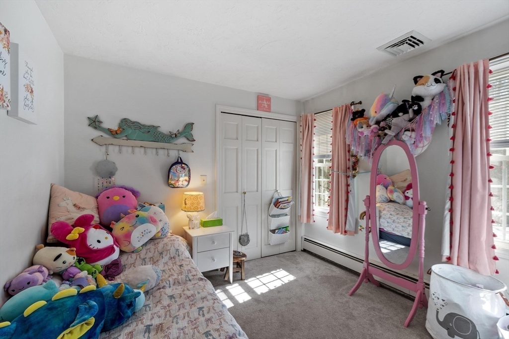 92 Prospect Street Lunenburg, MA 01462 - Photo 29 of 42 a bedroom with a bed a couch and dresser