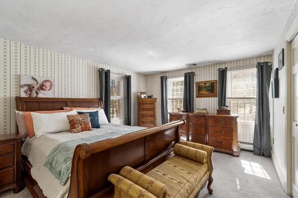 a bedroom with a bed and glass window