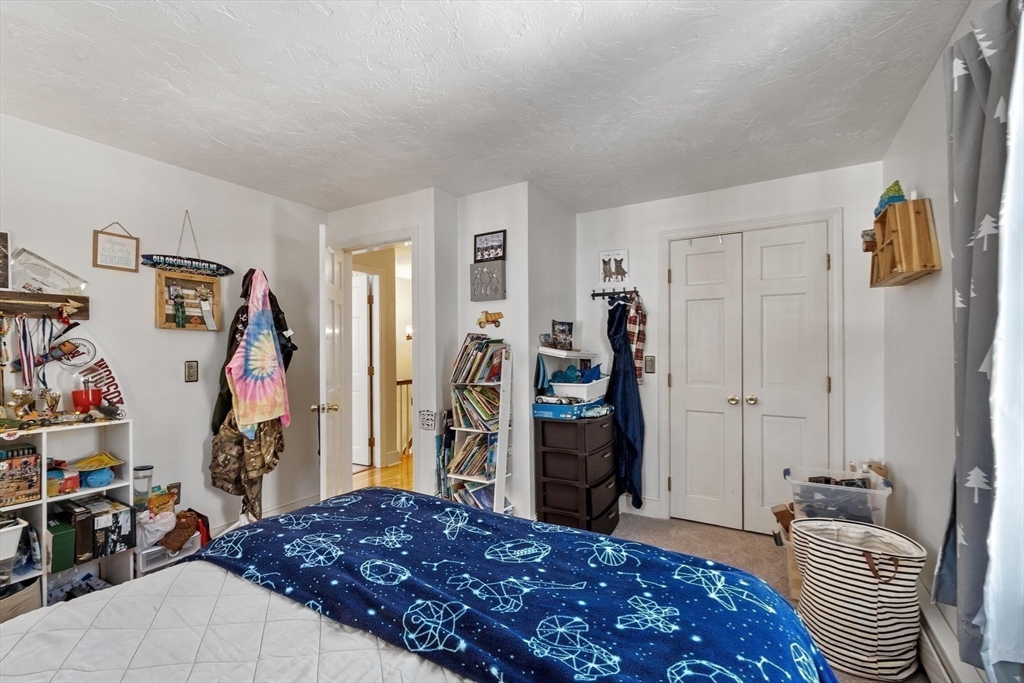 92 Prospect Street Lunenburg, MA 01462 - Photo 34 of 42 a bedroom with a bed and a closet