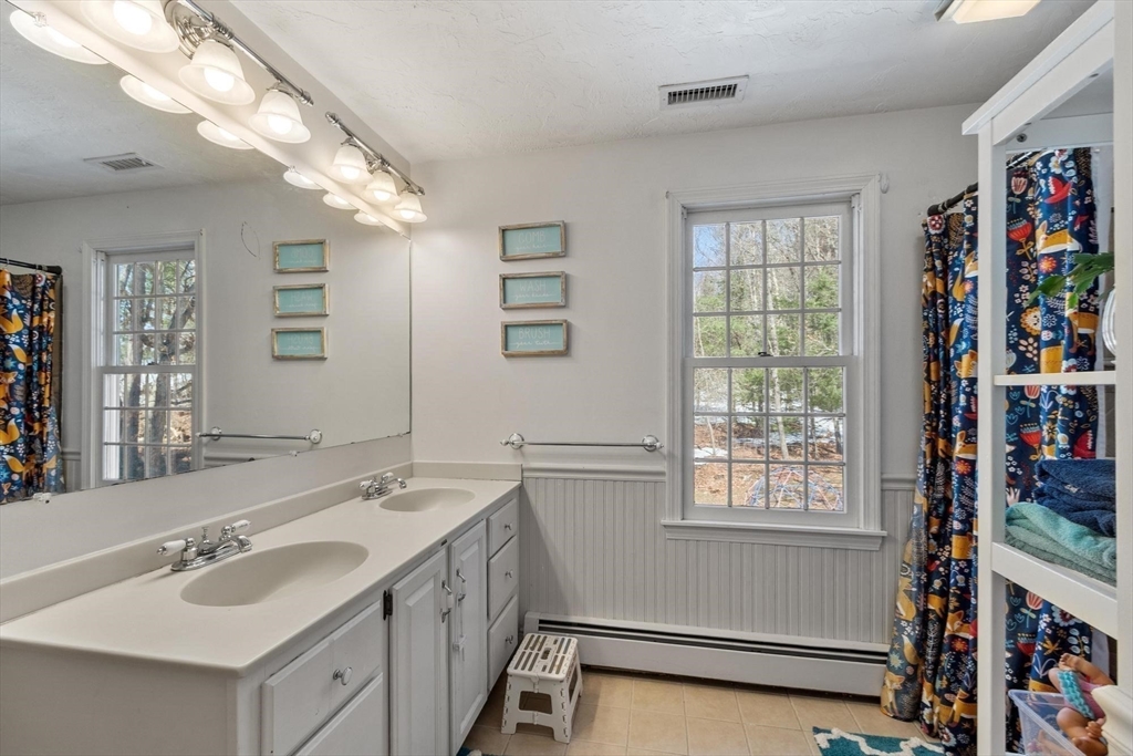 92 Prospect Street Lunenburg, MA 01462 - Photo 35 of 42 a bathroom with a sink double vanity and window