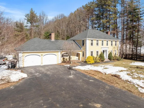 a view of a house with snow on the road