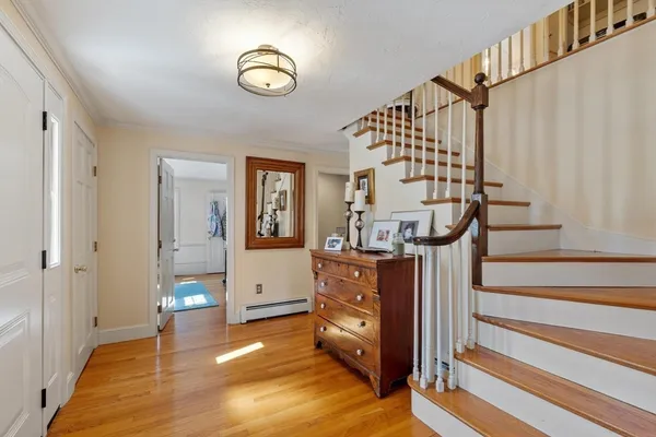 a view of entryway and hall with wooden floor
