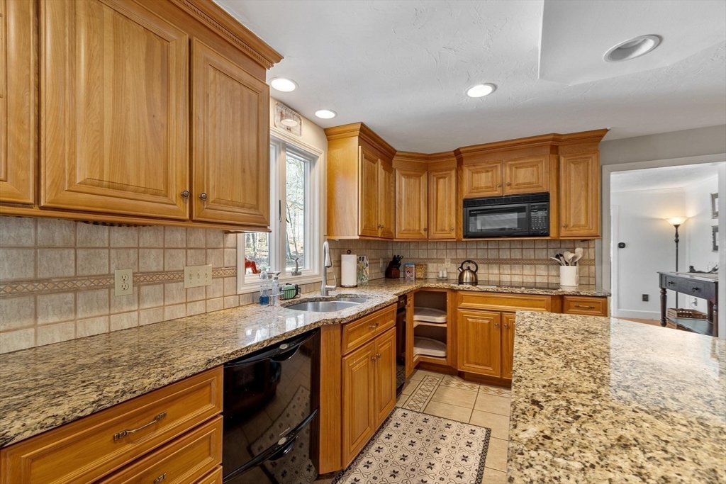 92 Prospect Street Lunenburg, MA 01462 - Photo 8 of 42 a kitchen with stainless steel appliances granite countertop a sink stove and cabinets