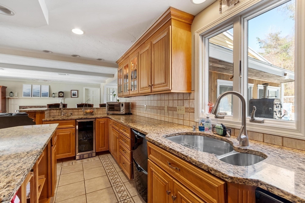 92 Prospect Street Lunenburg, MA 01462 - Photo 10 of 42 a kitchen with granite countertop a sink and a counter top space