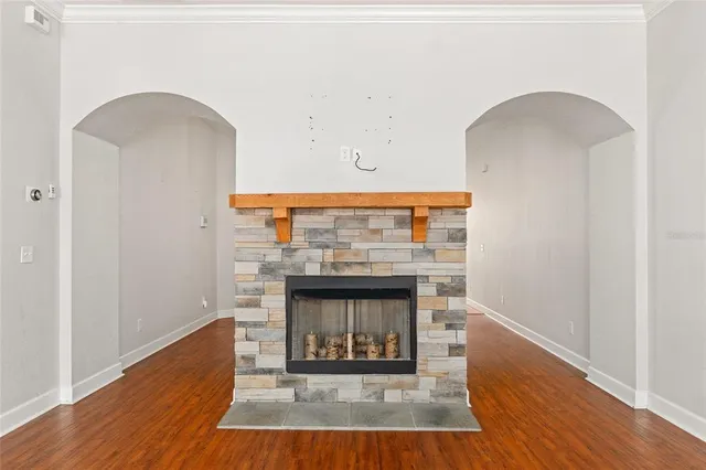 a room with fireplace and a wooden floor