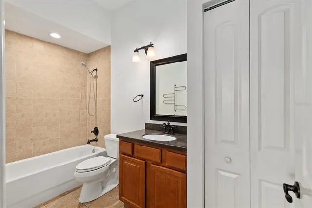 a bathroom with a granite countertop sink toilet mirror and shower