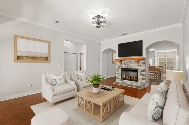 a living room with furniture a fireplace and a flat screen tv