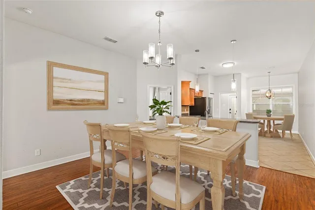 a view of a dining room with furniture wooden floor and chandelier