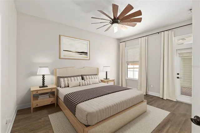 a bedroom with a large bed and a chandelier