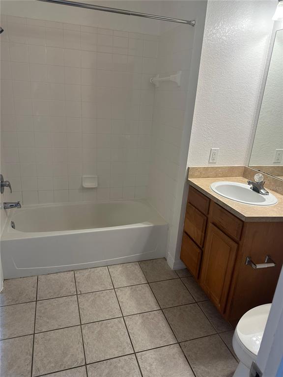 6157 Metrowest Boulevard, Unit 304 Orlando, FL 32835 - Photo 10 of 13 a bathroom with a sink a toilet and a tub