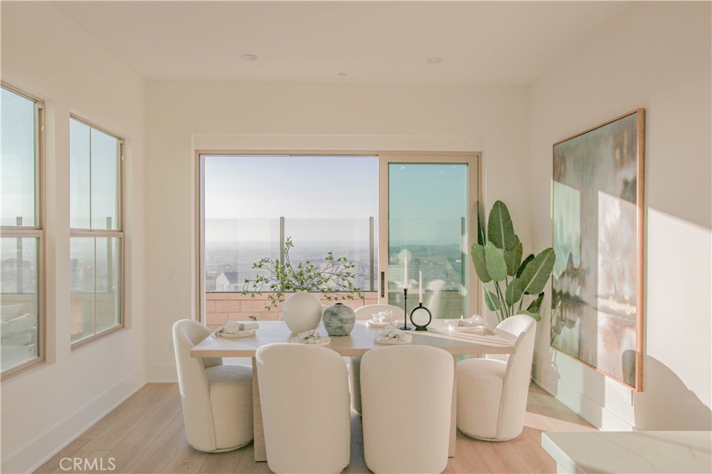 137 Oakstone Irvine, CA 92618 - Photo 16 of 23 a dining room with furniture a potted plant and a large window