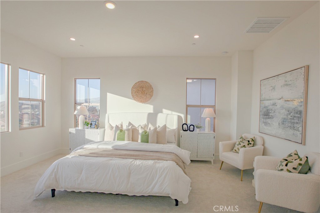 137 Oakstone Irvine, CA 92618 - Photo 21 of 23 a bedroom with a bed couch and window