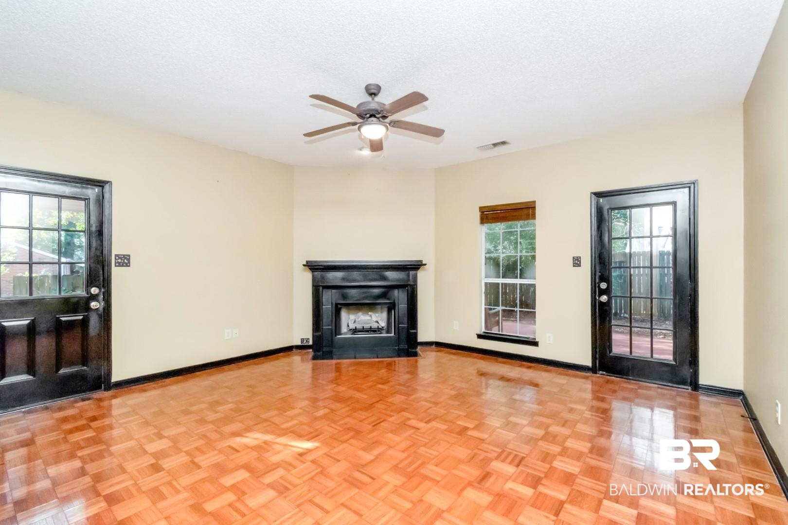 152 Ideal Avenue Mobile, AL 36608 - Photo 16 of 32 Unfurnished living room with a textured ceiling, light parquet flooring, and ceiling fan