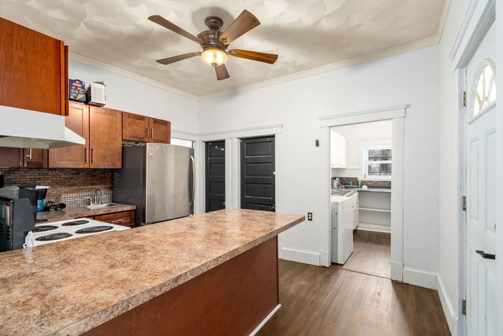 3 Park Street Webster, MA 01570 - Photo 12 of 19 a kitchen with stainless steel appliances granite countertop a refrigerator a sink a stove and oven a wooden floors