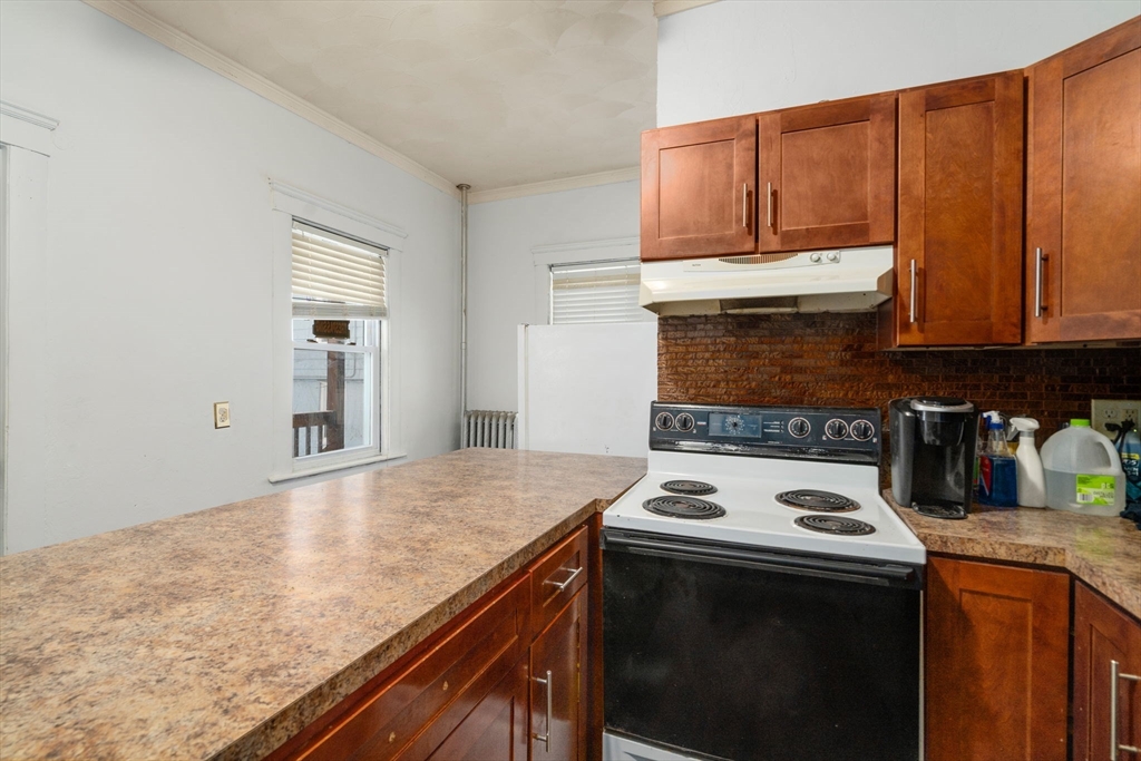 3 Park Street Webster, MA 01570 - Photo 13 of 19 a kitchen with granite countertop a stove top oven microwave and cabinets
