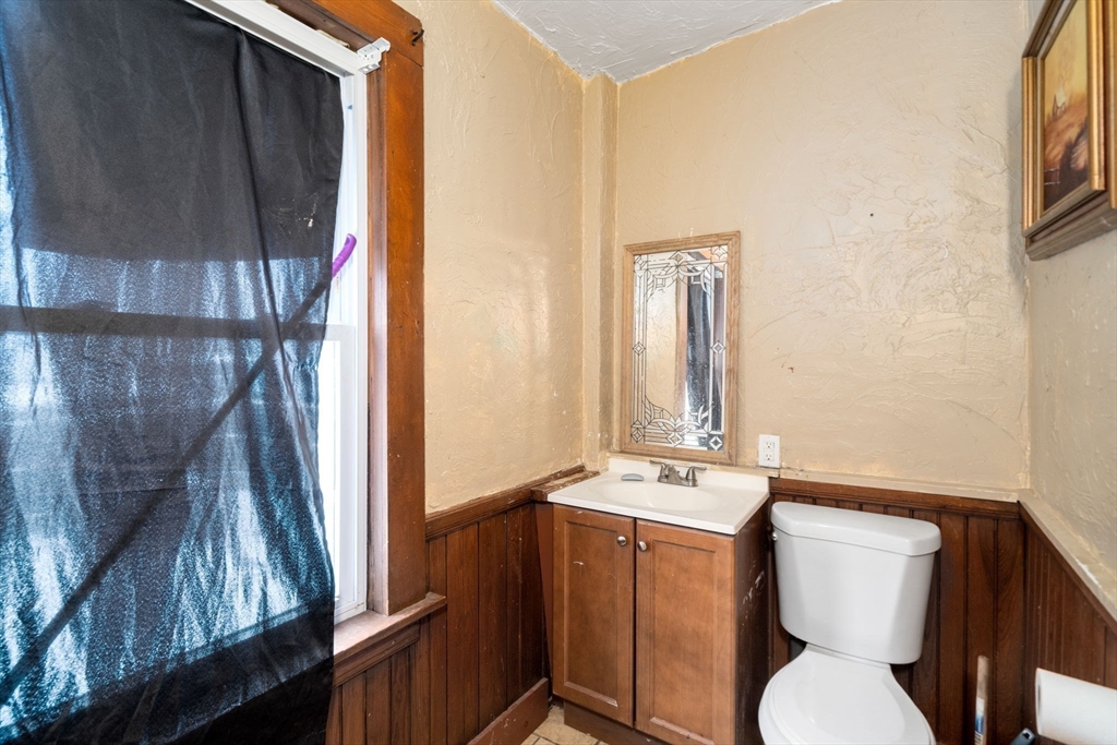 3 Park Street Webster, MA 01570 - Photo 17 of 19 a bathroom with a toilet sink and mirror
