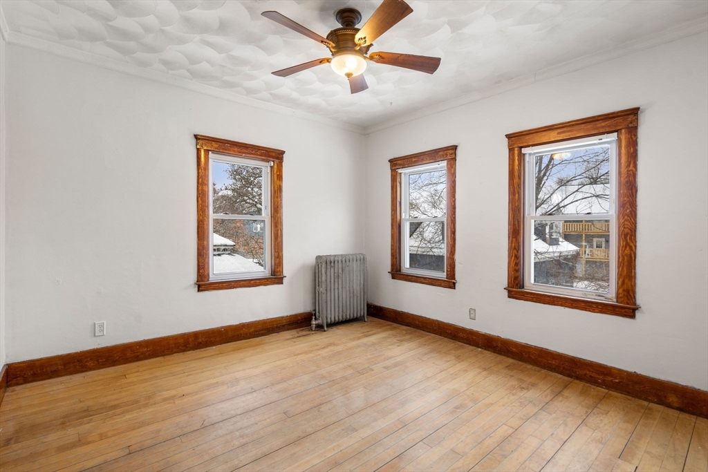 3 Park Street Webster, MA 01570 - Photo 8 of 19 a view of an empty room with window and wooden floor