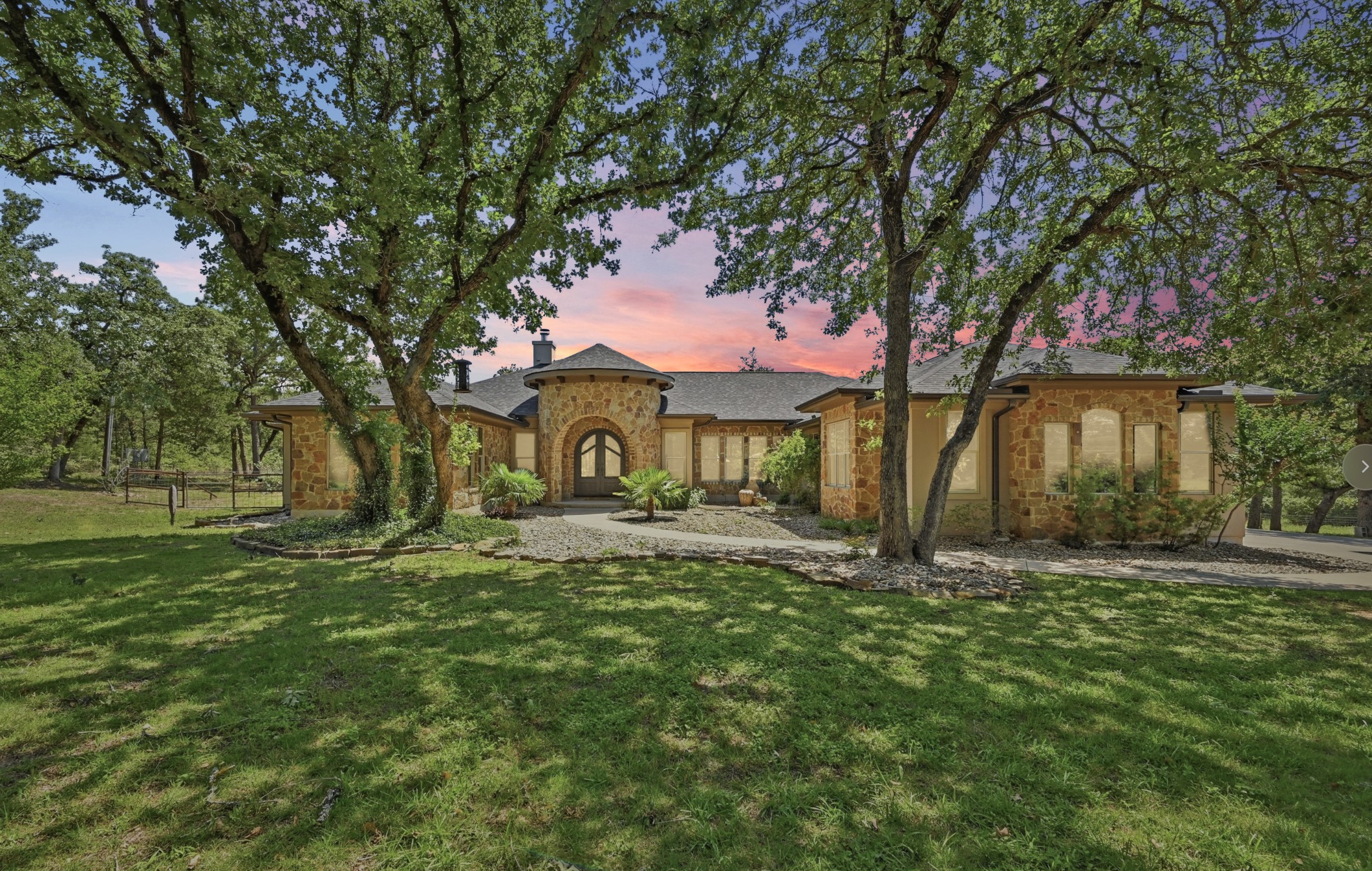 387 Corral Road Smithville, TX 78957 - Photo 3 of 40 Stone veneer exterior featuring a prominent arched entry