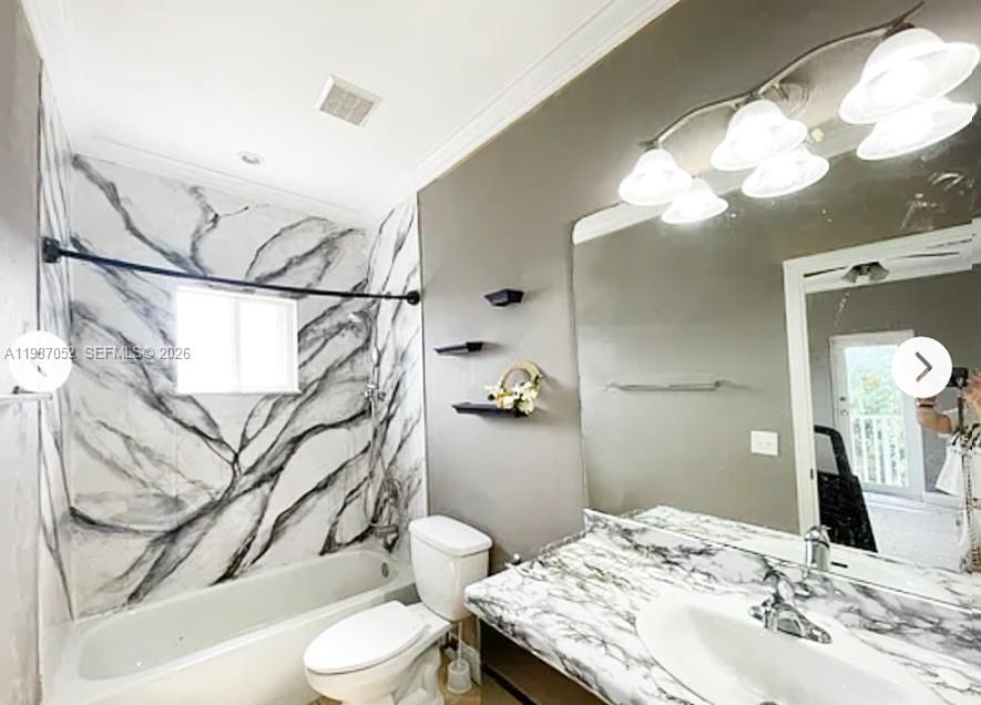 1102 Northwest 26th Street, Unit 1102 Miami, FL 33127 - Photo 18 of 39 a bathroom with a granite countertop sink toilet and shower