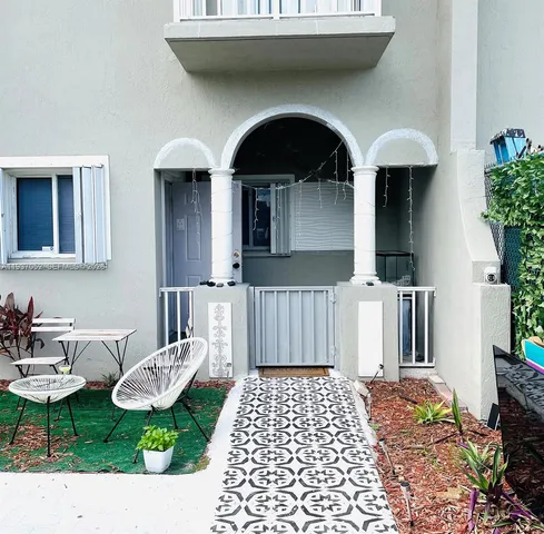 a living room with furniture a flat screen tv and potted plant
