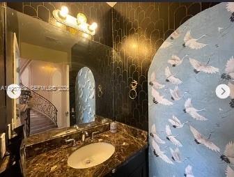 1102 Northwest 26th Street, Unit 1102 Miami, FL 33127 - Photo 21 of 39 a bathroom with a mirror sink and vanity