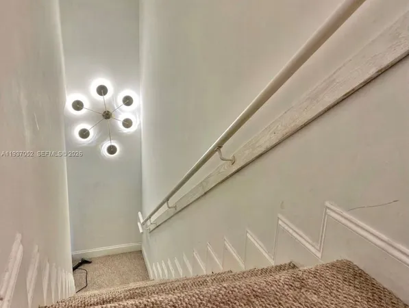 a view of staircase with white walls