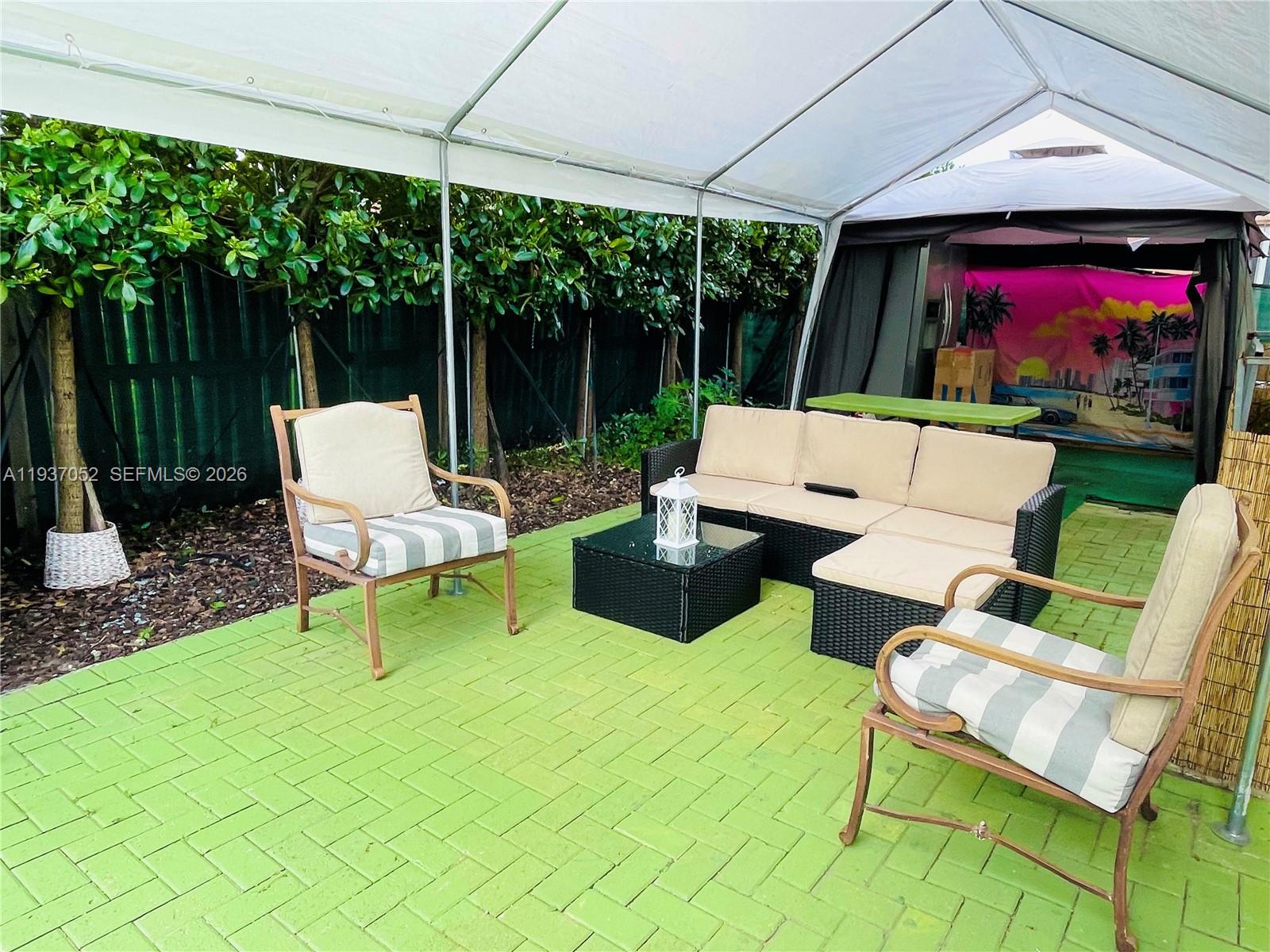 1102 Northwest 26th Street, Unit 1102 Miami, FL 33127 - Photo 25 of 39 a outdoor living space with furniture and garden view