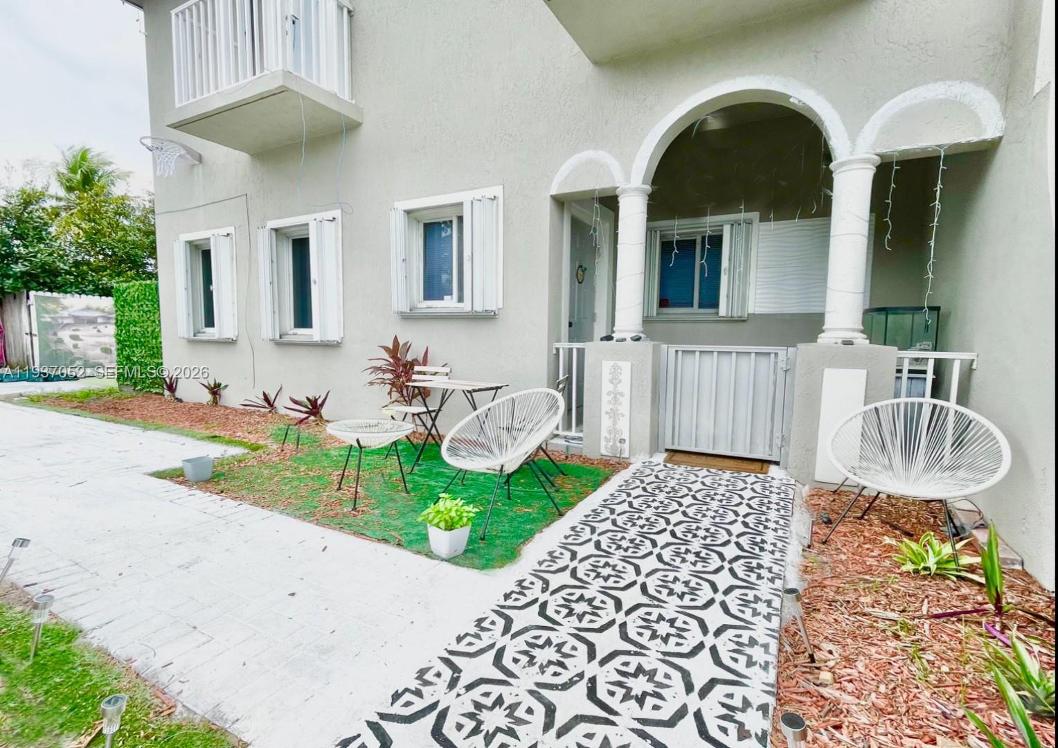 1102 Northwest 26th Street, Unit 1102 Miami, FL 33127 - Photo 27 of 39 a front view of a house with garden