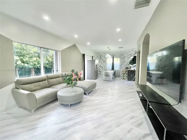 a living room with furniture and a large window