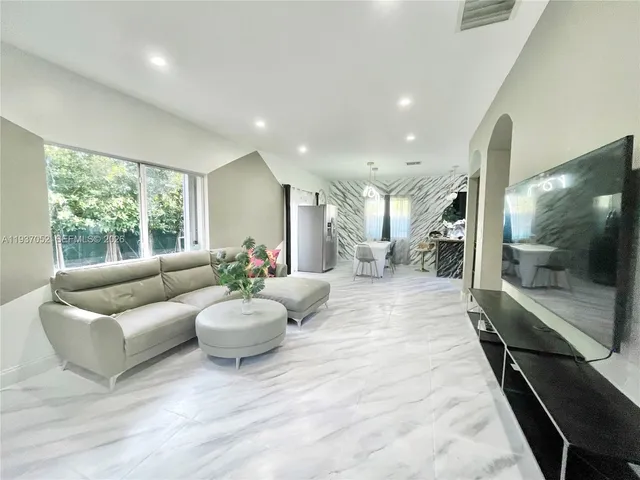 a kitchen with stainless steel appliances granite countertop a refrigerator and stove