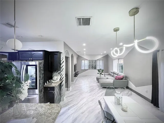 a bathroom with a sink vanity granite tub and a mirror