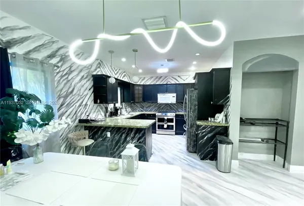 a kitchen with a table and chairs