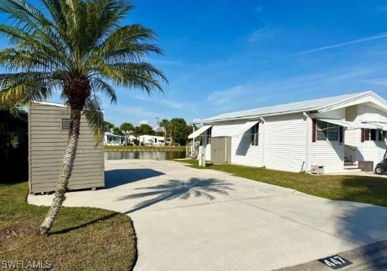 447 Cheetah Drive Naples, FL 34114 - Photo 16 of 42 a front view of a house with a yard