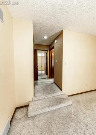 a view of a room with wooden floor and windows