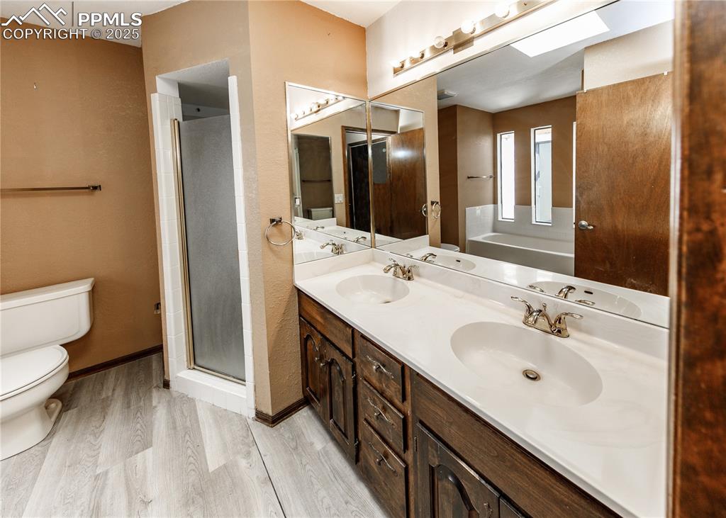55 Bonnymede Road, Unit S Pueblo, CO 81001 - Photo 14 of 24 a spacious bathroom with a double vanity sink toilet and shower