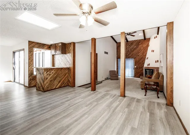 a view of living room kitchen with furniture and wooden floor