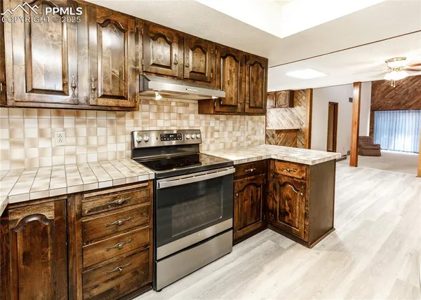a kitchen with stainless steel appliances granite countertop a stove and a sink