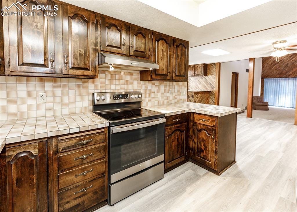 55 Bonnymede Road, Unit S Pueblo, CO 81001 - Photo 7 of 24 a kitchen with stainless steel appliances granite countertop a stove and a sink