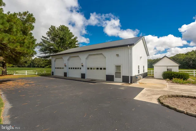 a view of a house with a yard and garage