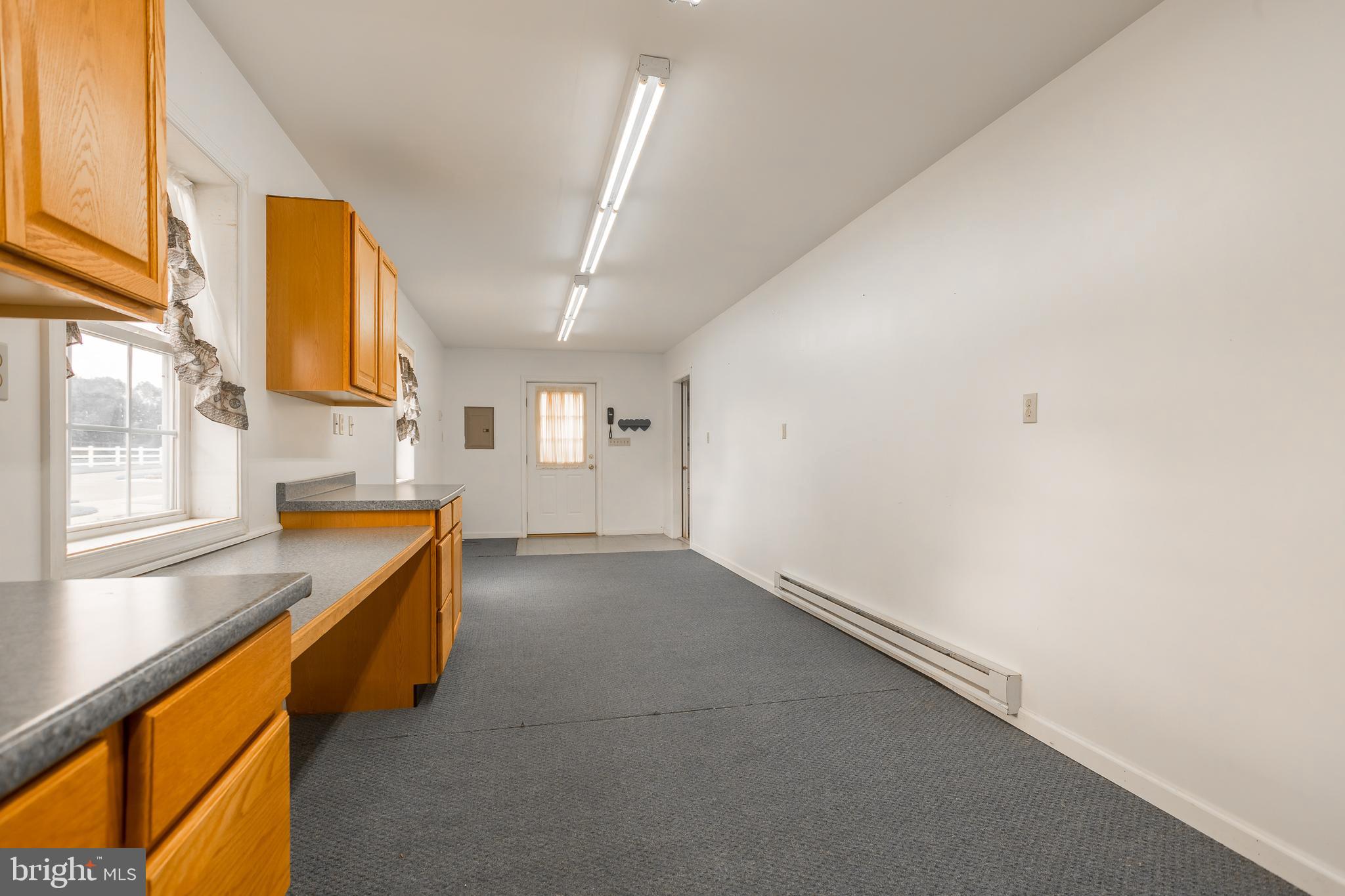 7751 Dividing Creek Road Pocomoke City, MD 21851 - Photo 22 of 51 a kitchen with stainless steel appliances a sink and cabinets