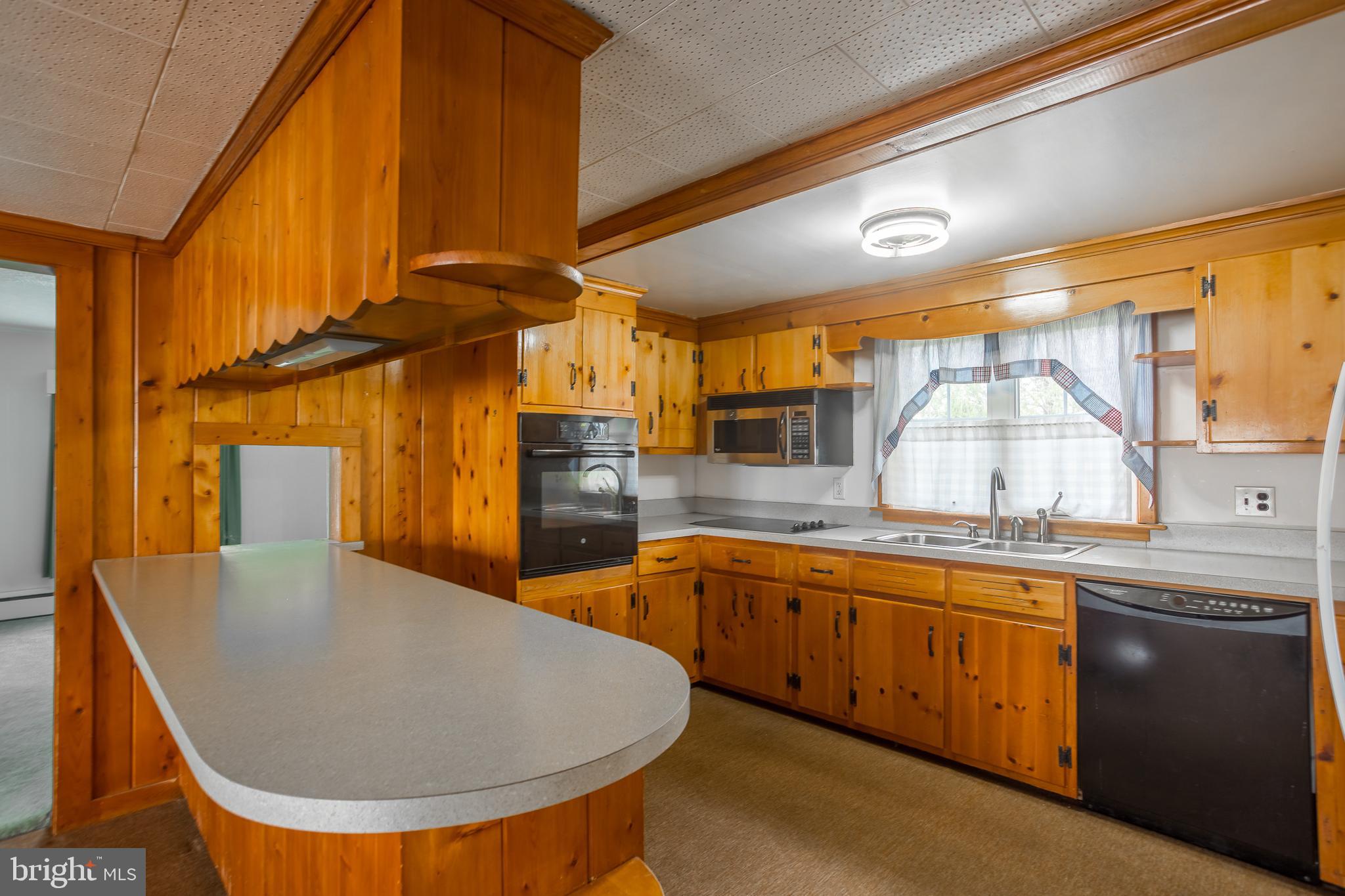 7751 Dividing Creek Road Pocomoke City, MD 21851 - Photo 33 of 51 a kitchen with stainless steel appliances granite countertop a sink and cabinets