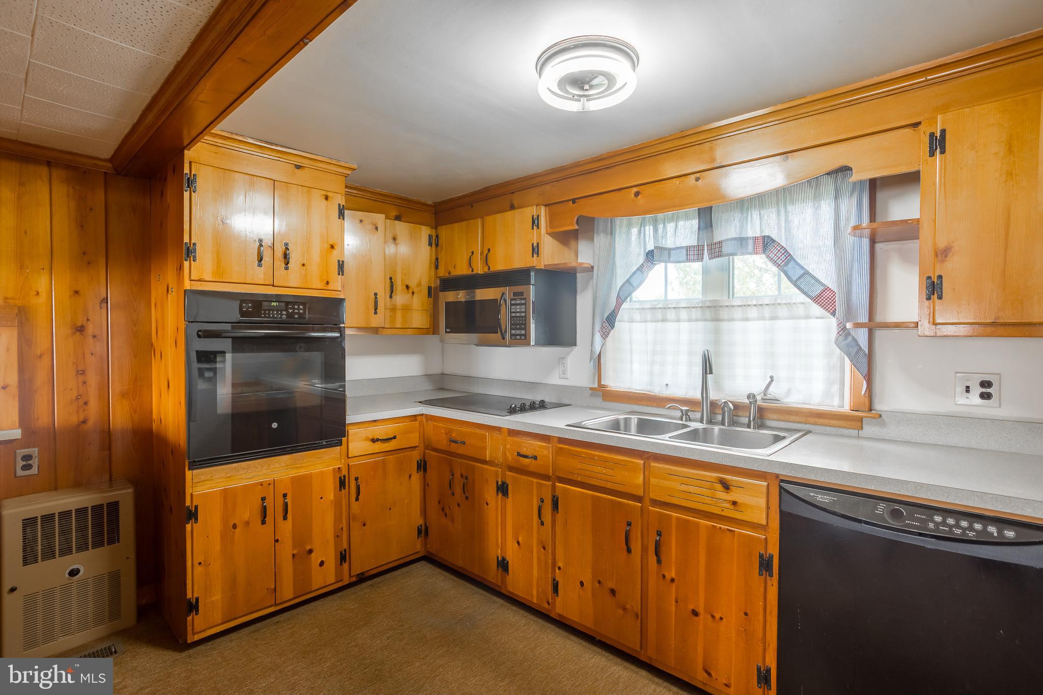 7751 Dividing Creek Road Pocomoke City, MD 21851 - Photo 35 of 51 a kitchen with stainless steel appliances granite countertop a sink and cabinets