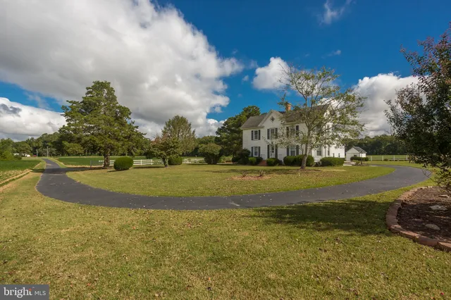 a front view of a house with a big yard