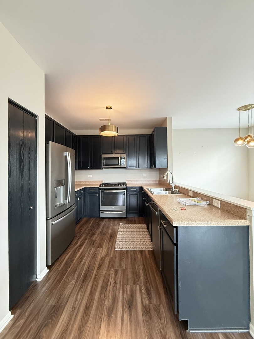 1586 Millbrook Drive Algonquin, IL 60102 - Photo 2 of 18 a kitchen with stainless steel appliances granite countertop a refrigerator a stove and a sink