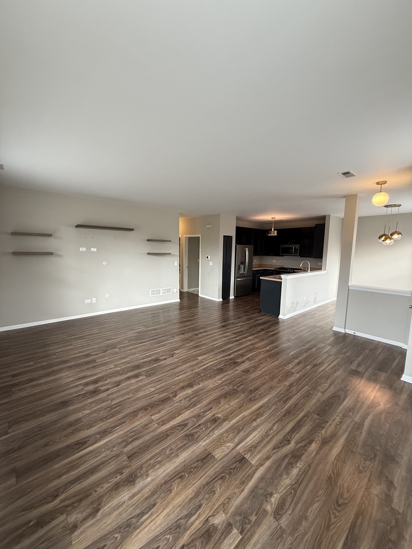 1586 Millbrook Drive Algonquin, IL 60102 - Photo 4 of 18 a view of empty room with wooden floor