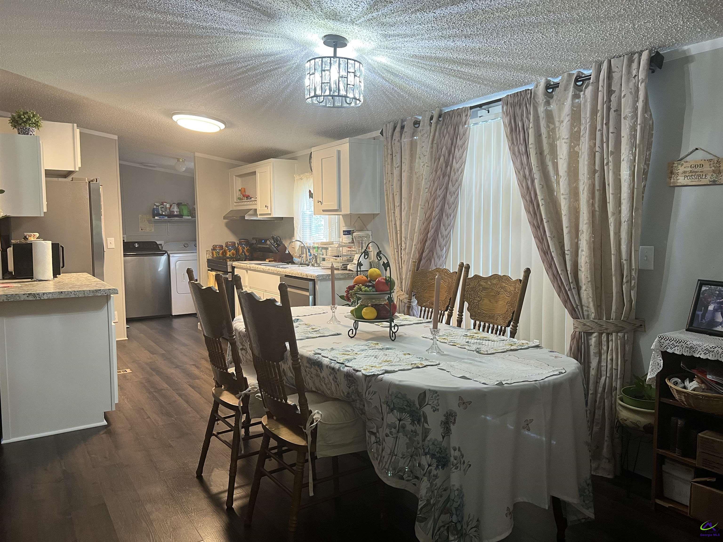 166 Pebble Hills Road Cochran, GA 31014 - Photo 13 of 27 a view of a dining room with furniture window and wooden floor